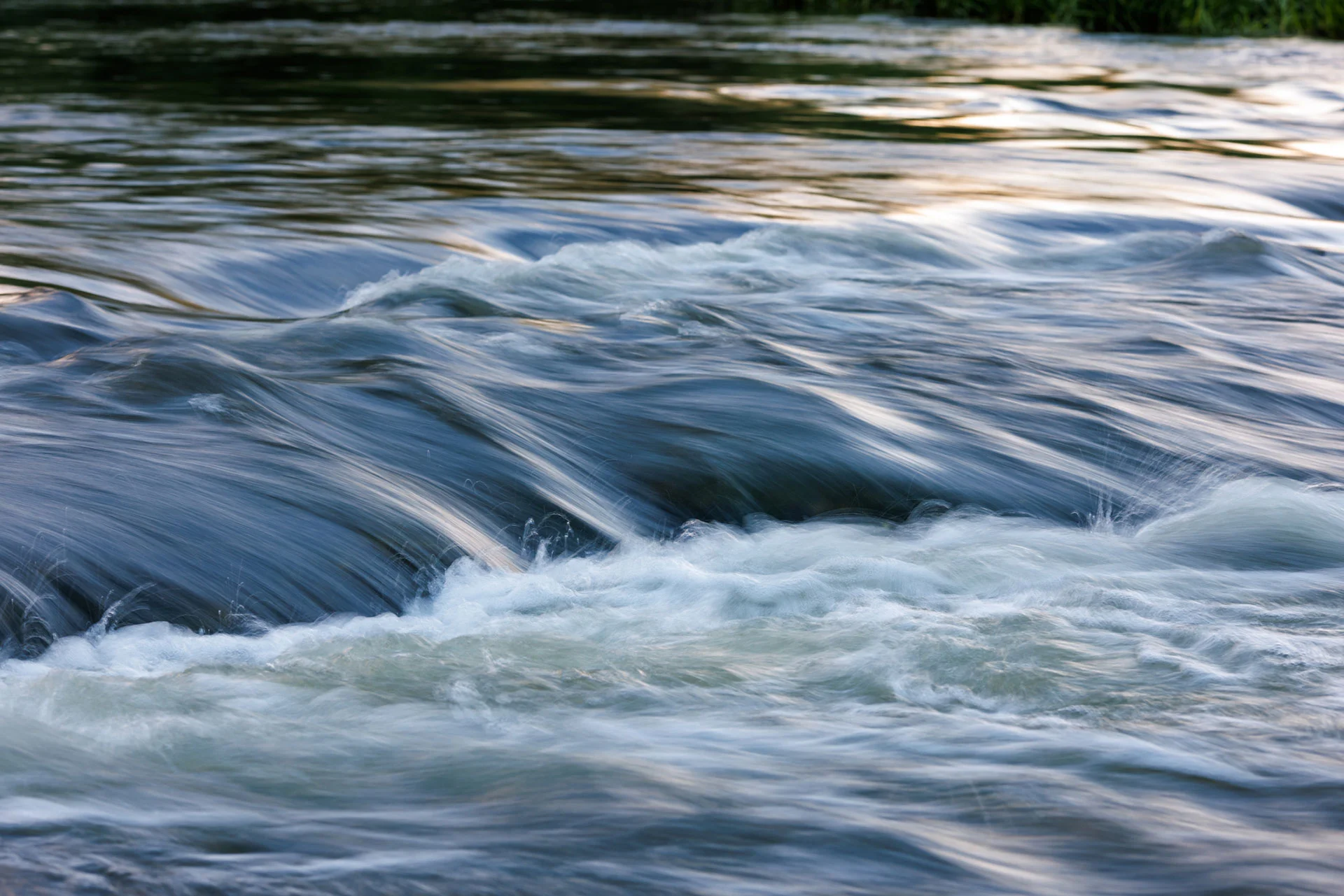 Flowing river water with soft, blurred motion.