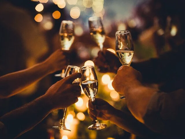 People toasting with champagne glasses at a celebration.