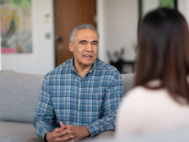 Older adult man communicating with a medical professional.