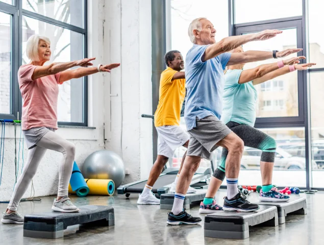Older adults participating in a group step exercise class.