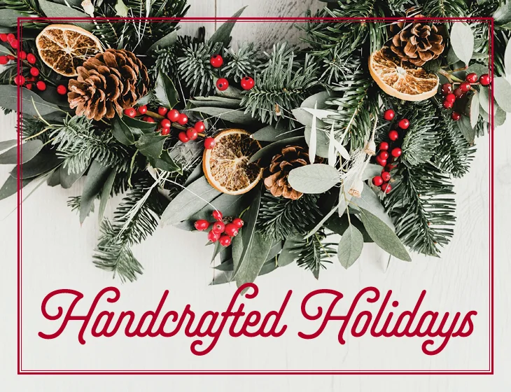 Decorative holiday wreath with text that reads, "Handcrafted Holidays"