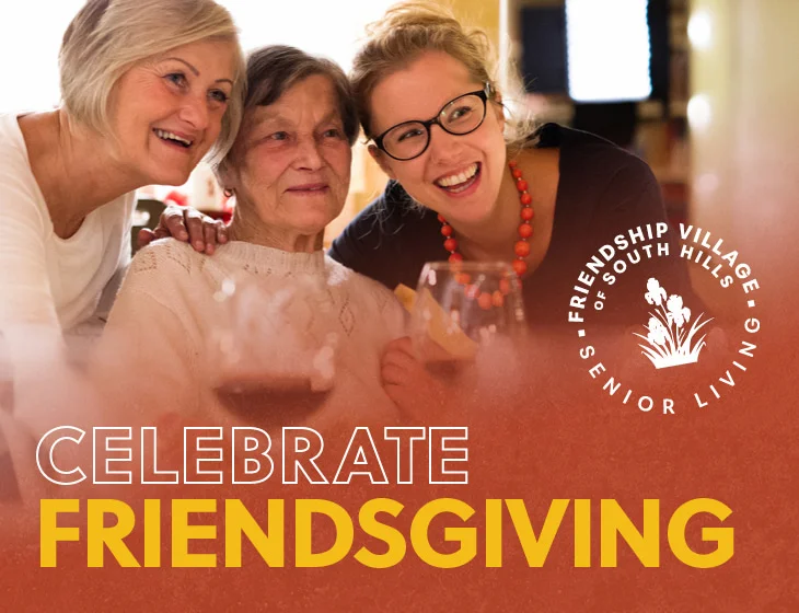 Two seniors with loved one gathered together smiling for photo with wine glasses. Text on image: Celebrate Friendsgiving.