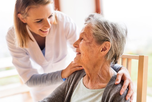 healthcare worker talking with a senior living resident