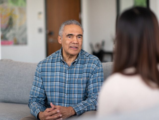 Older adult man communicating with a medical professional.