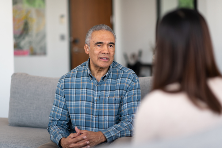 Older adult man communicating with a medical professional.