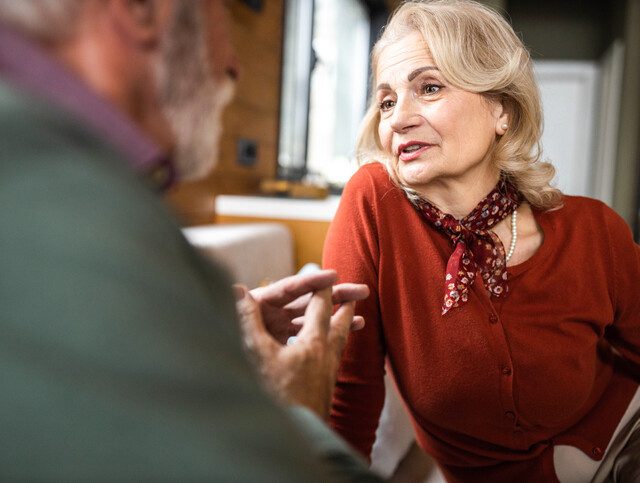 Older adult woman engaged in conversation on a date.