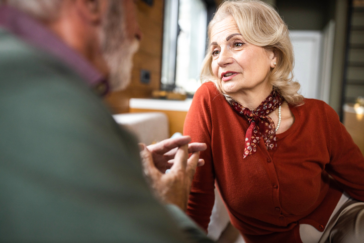 Older adult woman engaged in conversation on a date.